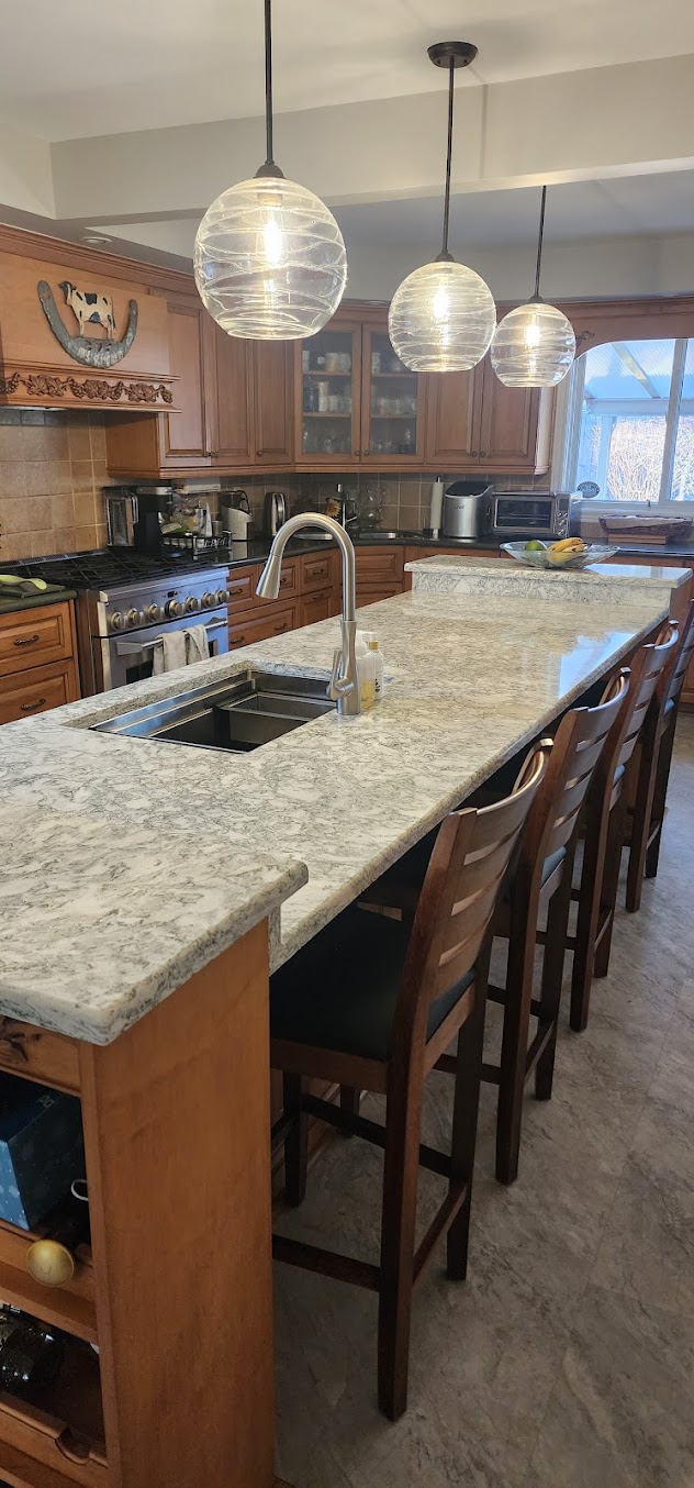 Granite kitchen island with long overhang and bar seating for everyday meals