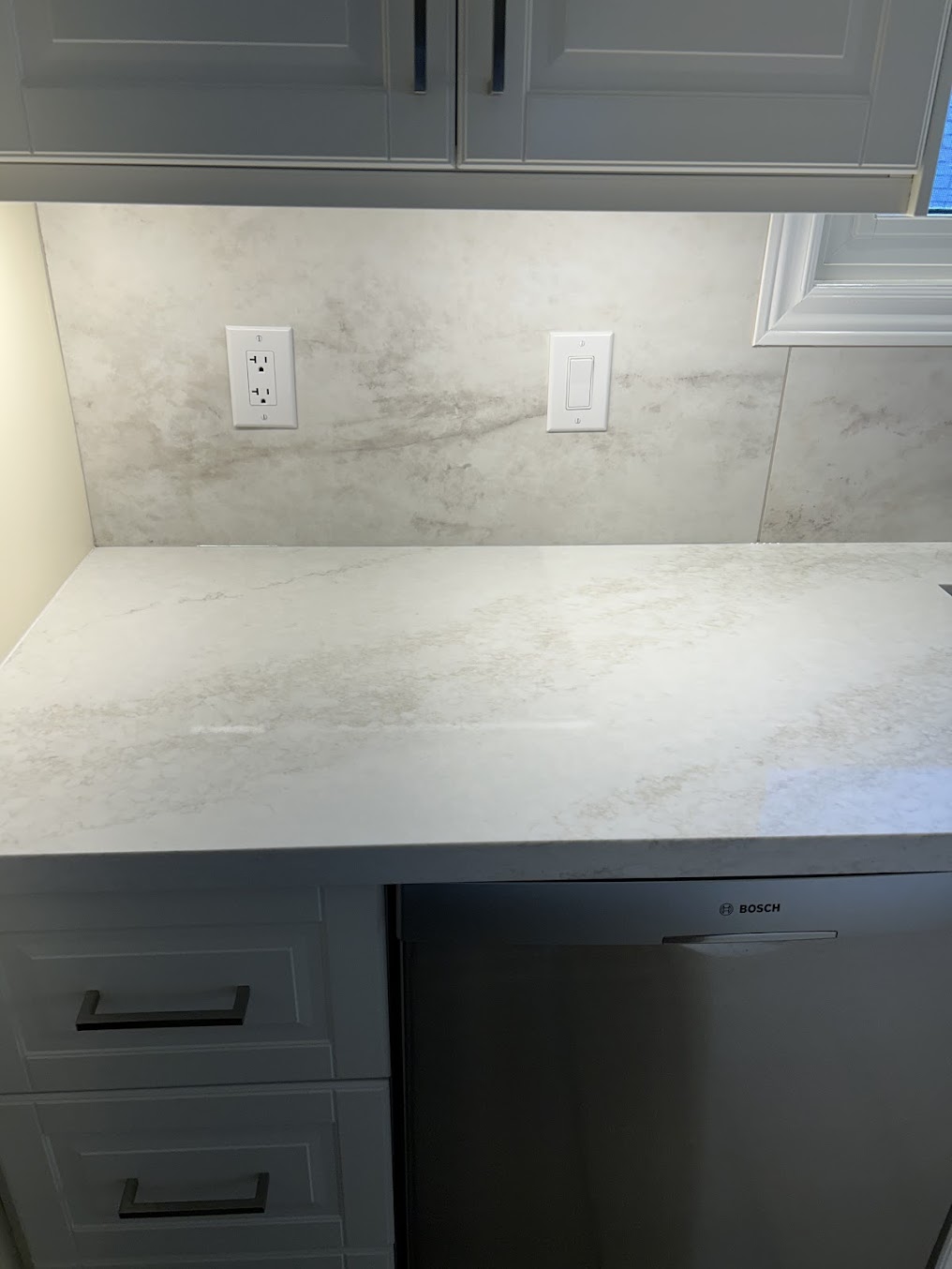 Matched countertop and backsplash detail showing careful stone fabrication